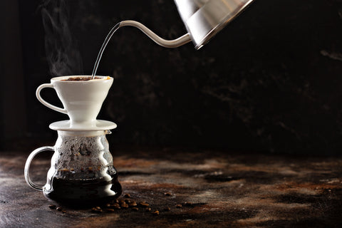 Hario V60 pour-over dripper brewing into a glass server